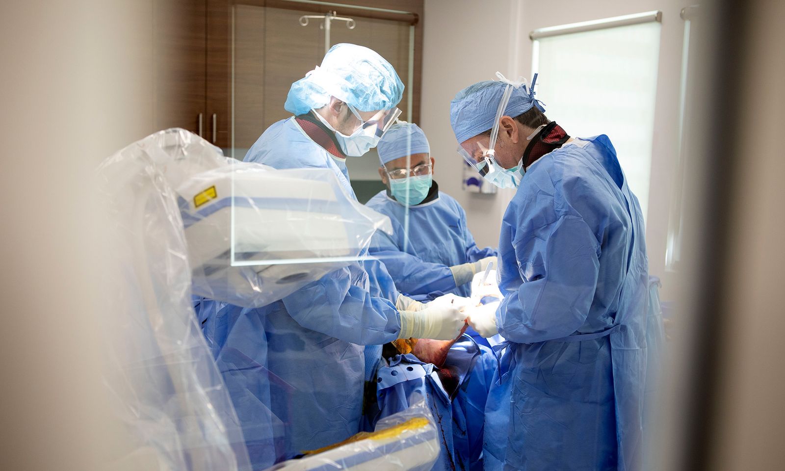 A team in surgery on a Bunionplasty® patient.